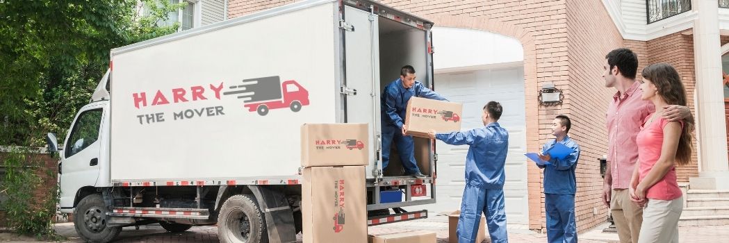 Professional movers from Harry The Mover in Melbourne efficiently loading and unloading moving boxes from a truck, ensuring a smooth and secure relocation process.