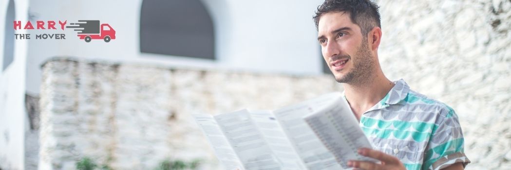 Man reading a checklist outdoors, representing moving tips and hacks by Harry The Mover, a trusted removalist in Melbourne.