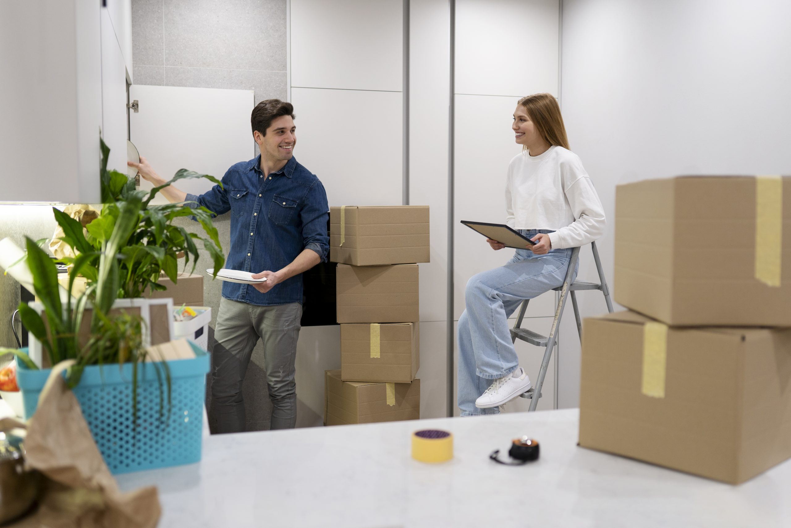 Professional mover from Harry the Mover delivering boxes to a happy family, showcasing their residential moving services.