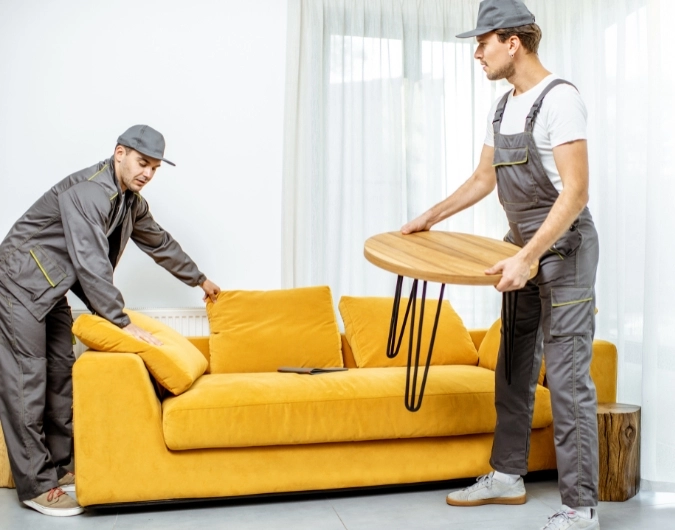 Harry The Mover furniture removalists in Melbourne carefully moving sofa and table during relocation.