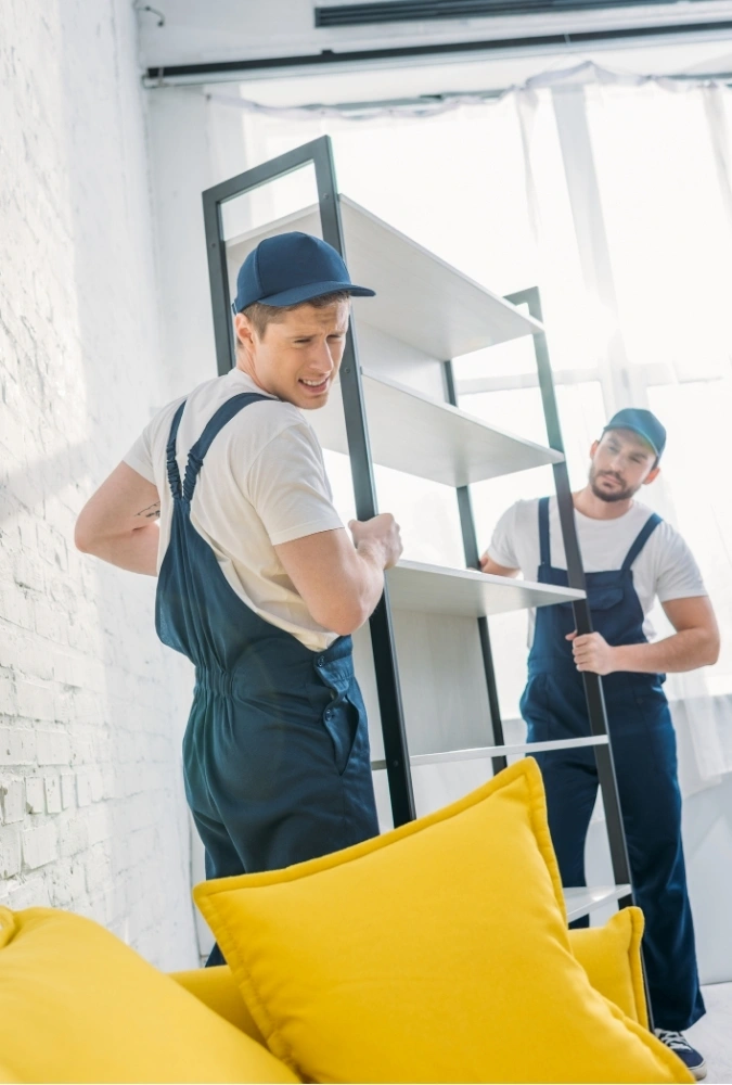 Professional furniture movers in Adelaide lifting a heavy shelf during home relocation Professional furniture movers in Adelaide lifting a heavy shelf during home relocation.